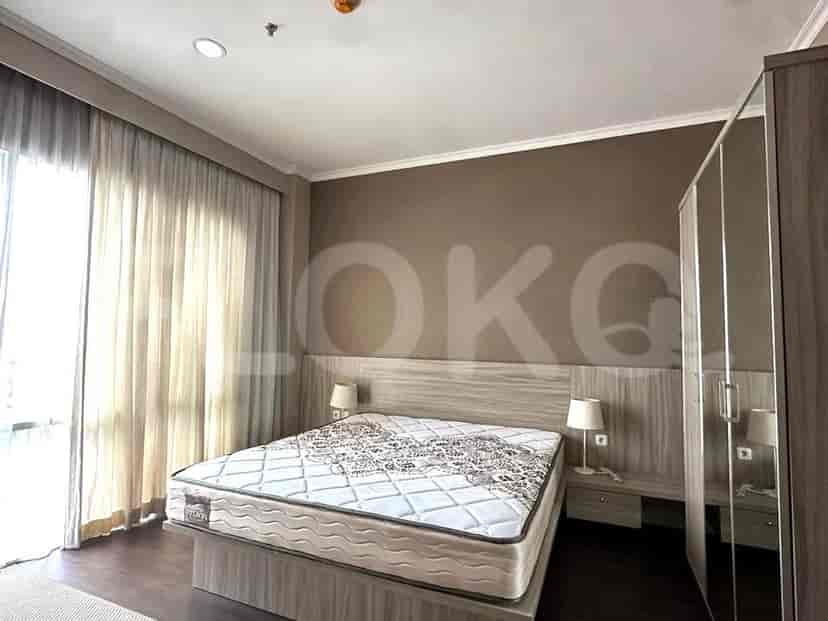 Bedroom with a queen bed, side tables, and a wardrobe.
