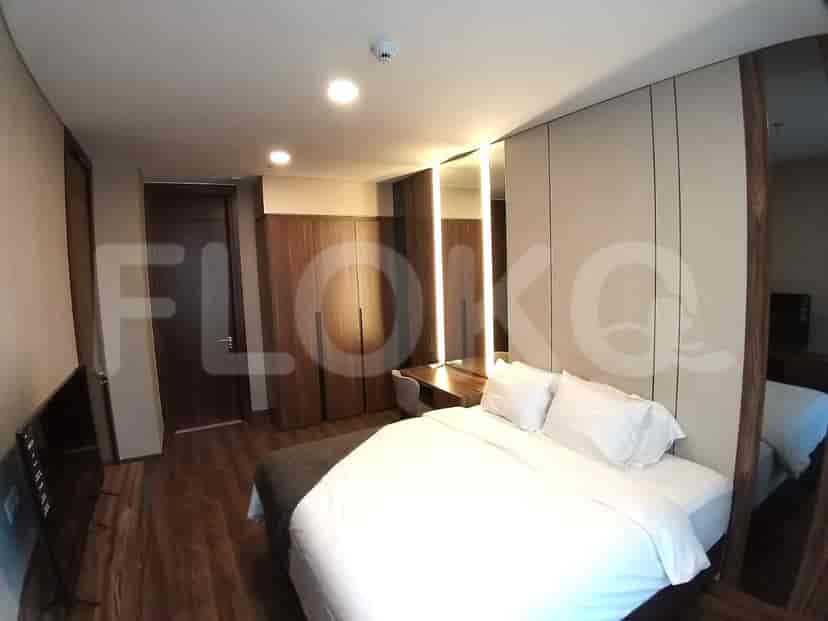 Modern bedroom with a king bed, desk, and ample closet space.
