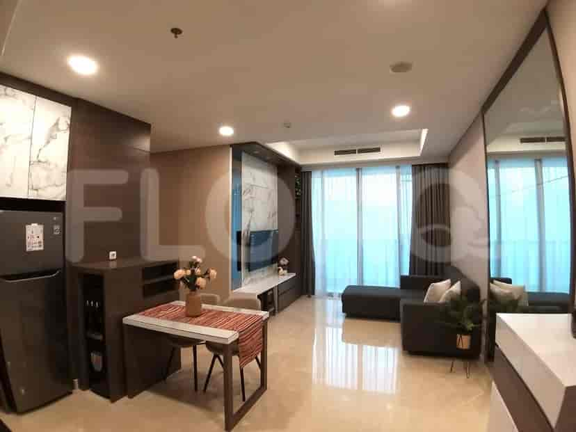 Modern living and dining space with marble accents, a dining table, a sofa, and a smart TV.