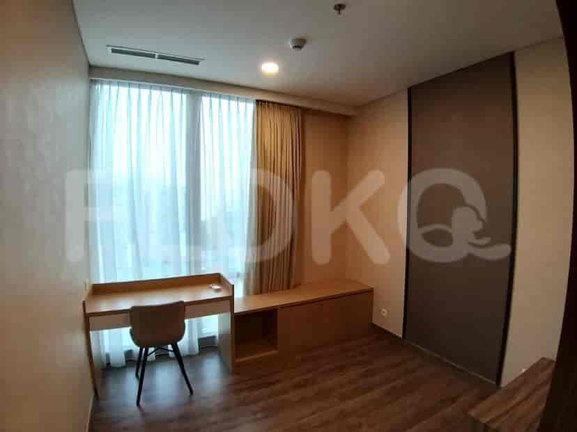 Bedroom with a study area including a desk and chair, featuring a window.