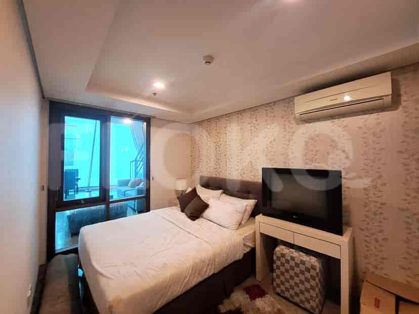 Kamar tidur dengan tempat tidur, TV, dan desain modern.