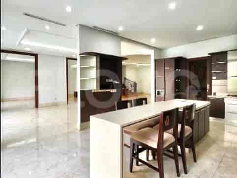 Kitchen with a seating area, wooden cabinets and stainless steel appliances.