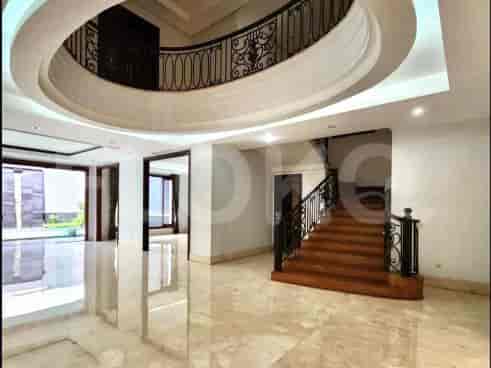 Spacious interior with a staircase and an oval ceiling, featuring marble flooring.