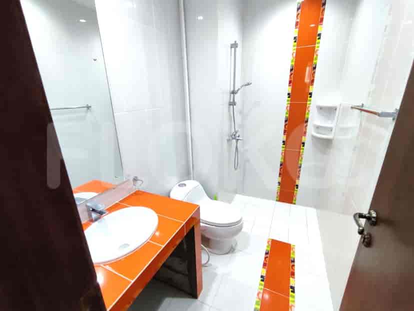 Modern bathroom with a toilet, sink, and shower.