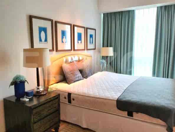 Bedroom with a bed, nightstand, and framed artwork.