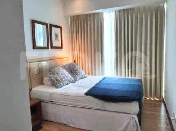 Bedroom with a bed, bedside tables and artwork