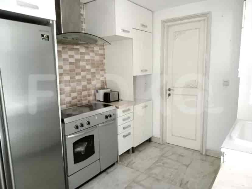 A modern kitchen with a refrigerator and stove.