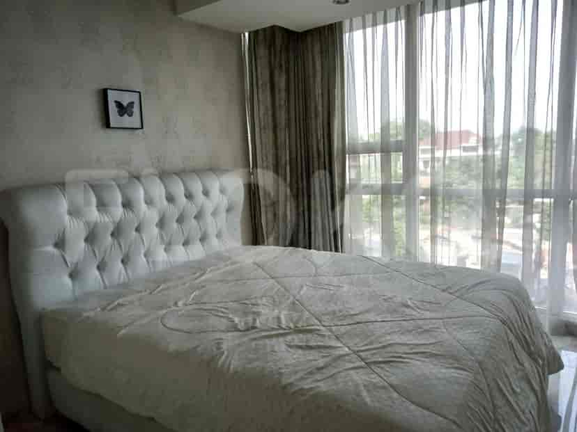 Bedroom with a bed, curtains, and decorative wallpaper.