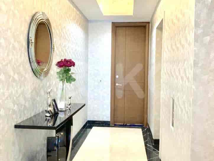 A modern hallway with a decorative console table and a large mirror.