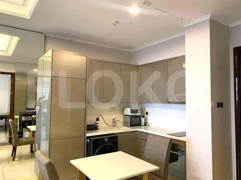Stylish kitchen with modern cabinets, appliances, and a dining table.