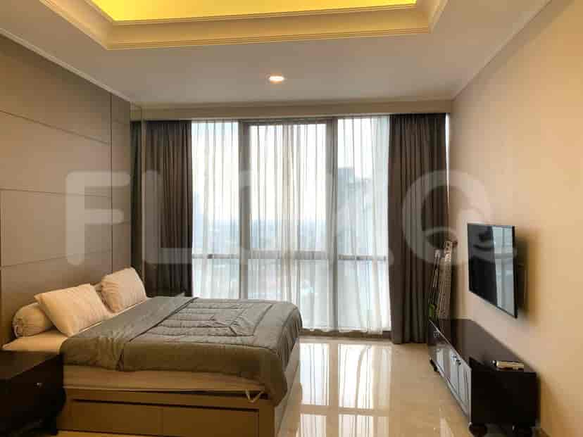 Bedroom with a bed and large windows.