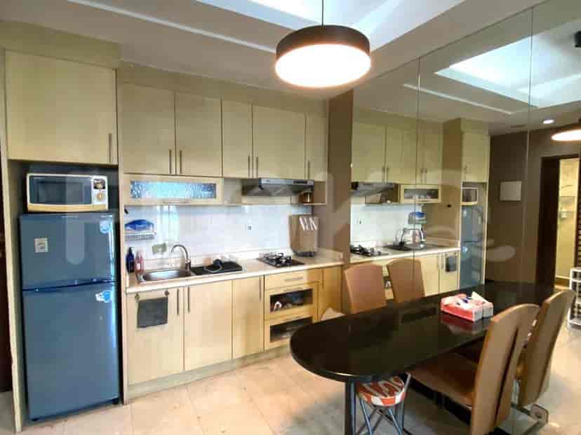 Kitchen featuring wooden cabinets, black dining table, and built-in appliances.