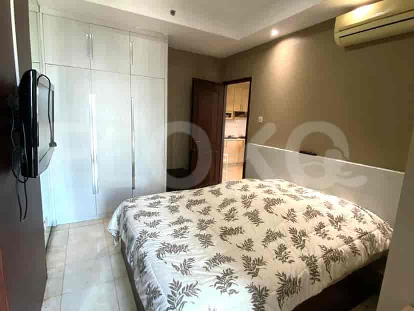 Bedroom featuring a double bed, white closet, and side table.