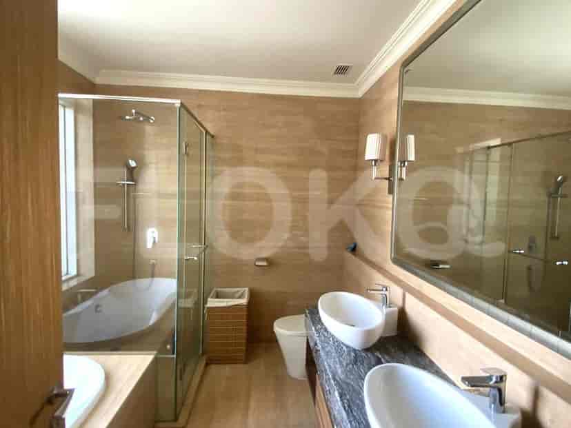 A modern bathroom with a double vanity, a bathtub, and a glass shower.