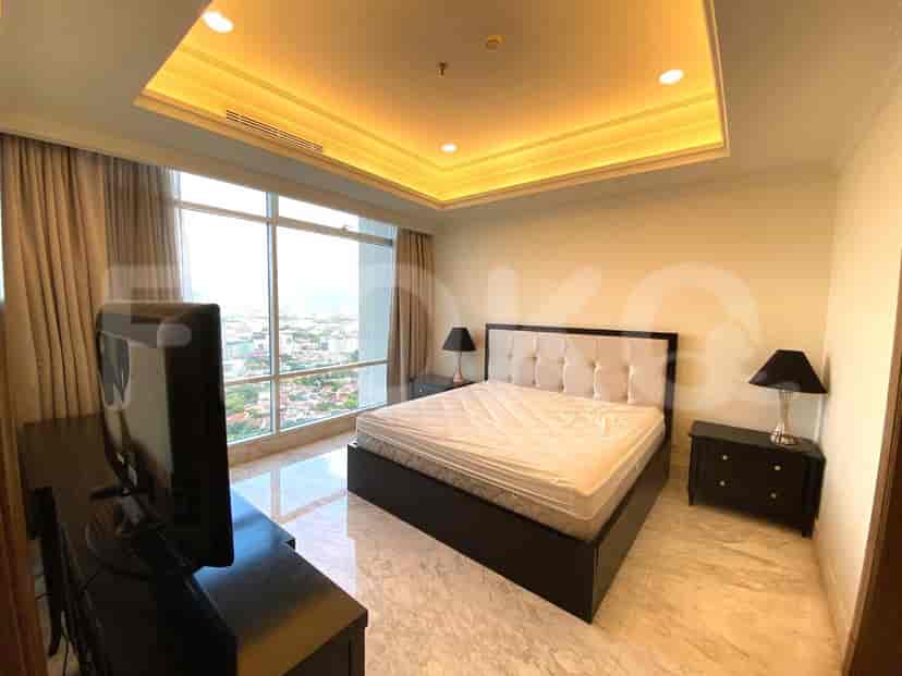 A bedroom with a king bed, a smart TV, and a large window with city views.
