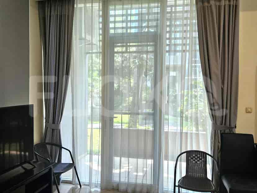 A balcony with large glass doors, and curtains.