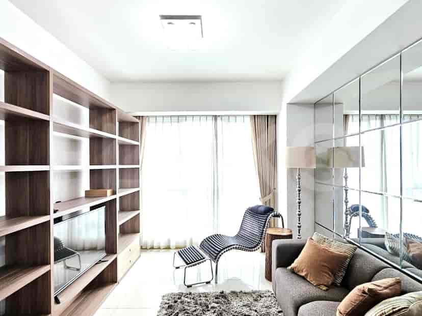 Modern living room with a sofa, shelving, and a statement chair.