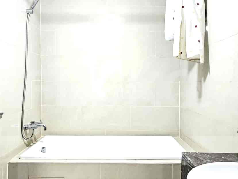 A simple and clean bathroom with a bathtub.