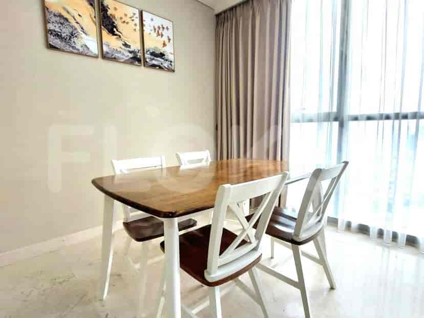 Dining area with wooden table and chairs.