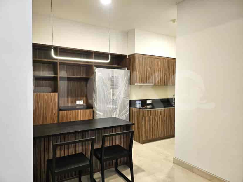 A contemporary kitchen with wooden cabinetry and a breakfast bar.