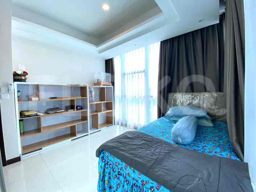 Bright and spacious bedroom with a double bed, shelving, and large windows.