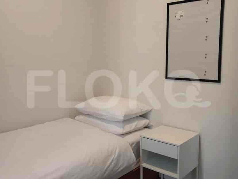Bedroom with a single bed, nightstand, and a picture frame.