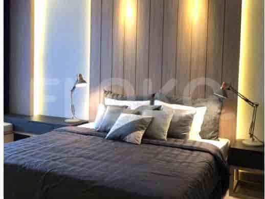 Bedroom featuring a bed, side tables, and lamps.