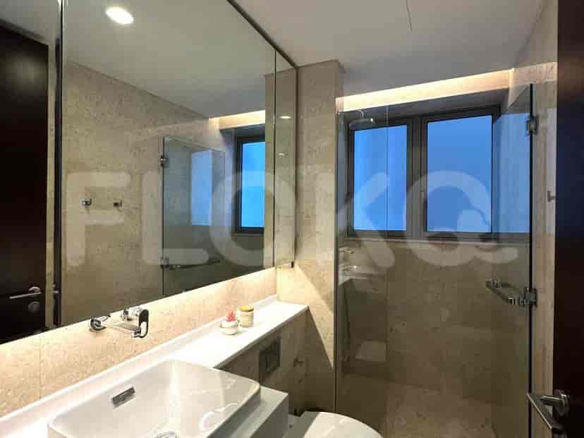 Bathroom with a large mirror and glass shower enclosure.