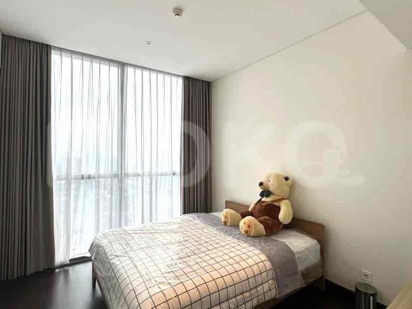 Bedroom with a bed, teddy bear, and curtains.