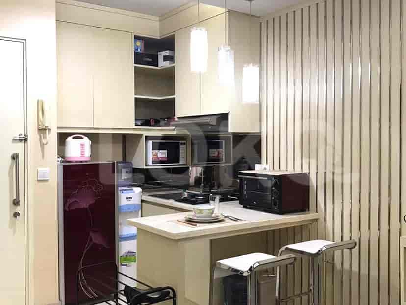 A compact kitchen with modern appliances and a breakfast bar.