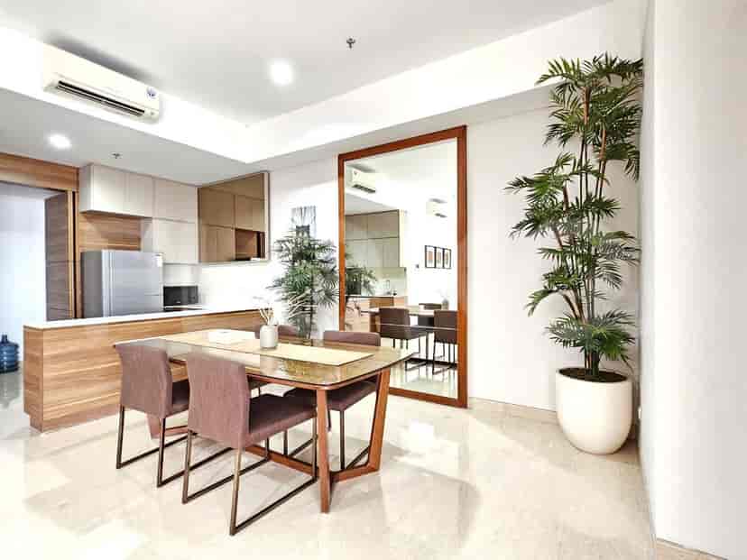 A dining area with a table and chairs, adjacent to a kitchen.