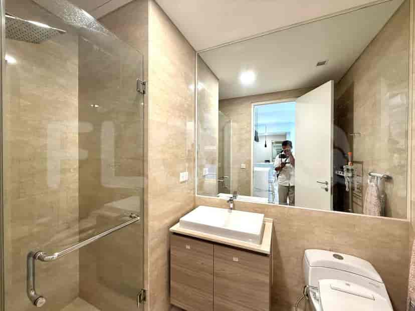A modern bathroom with a walk-in shower, vanity, and toilet.