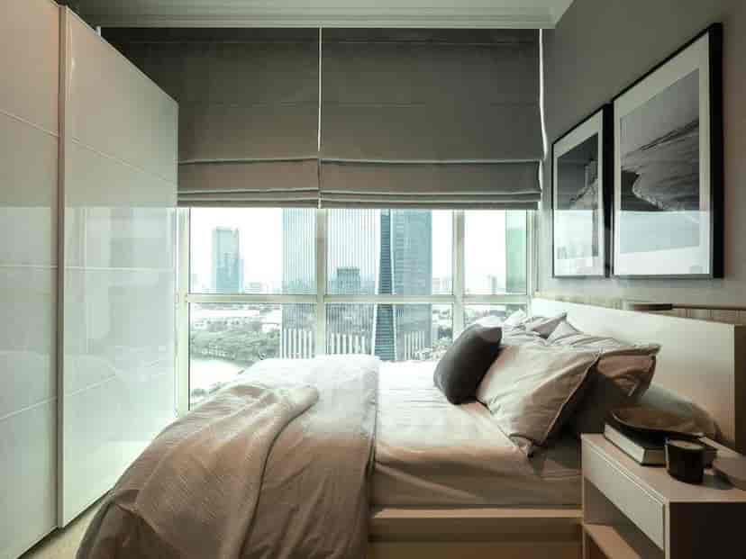 Another view of the bedroom, showcasing the bed and window.