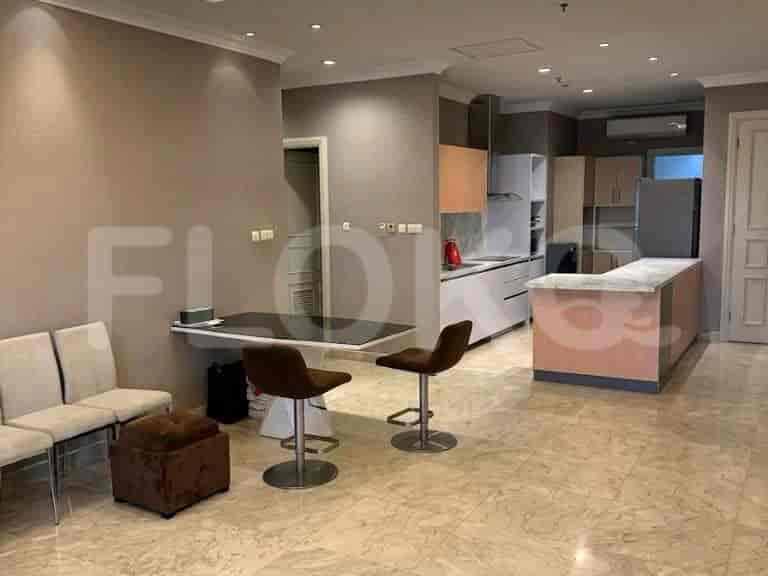 A modern open-plan living and dining area with a kitchen island, dining table, and seating area.
