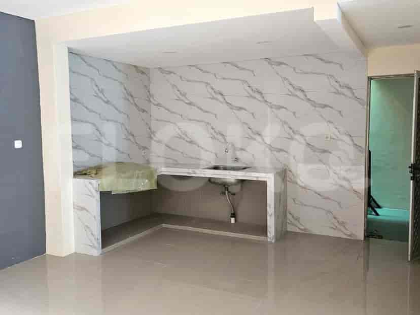 An open kitchen area with a marble countertop, sink, and marble backsplash.