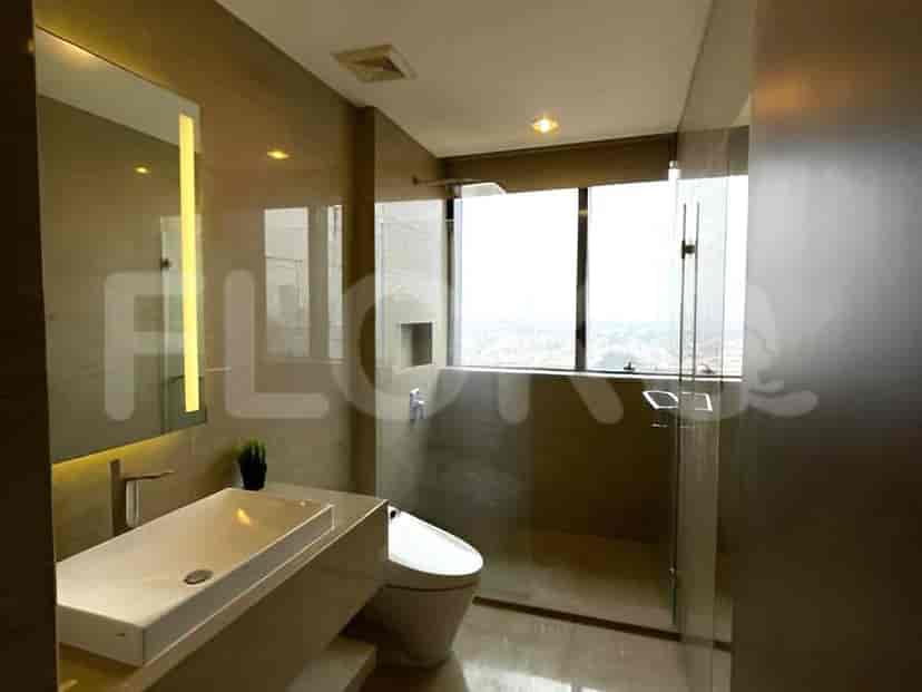 A modern bathroom with a floating vanity, a wall-mounted toilet, and a glass-enclosed shower.