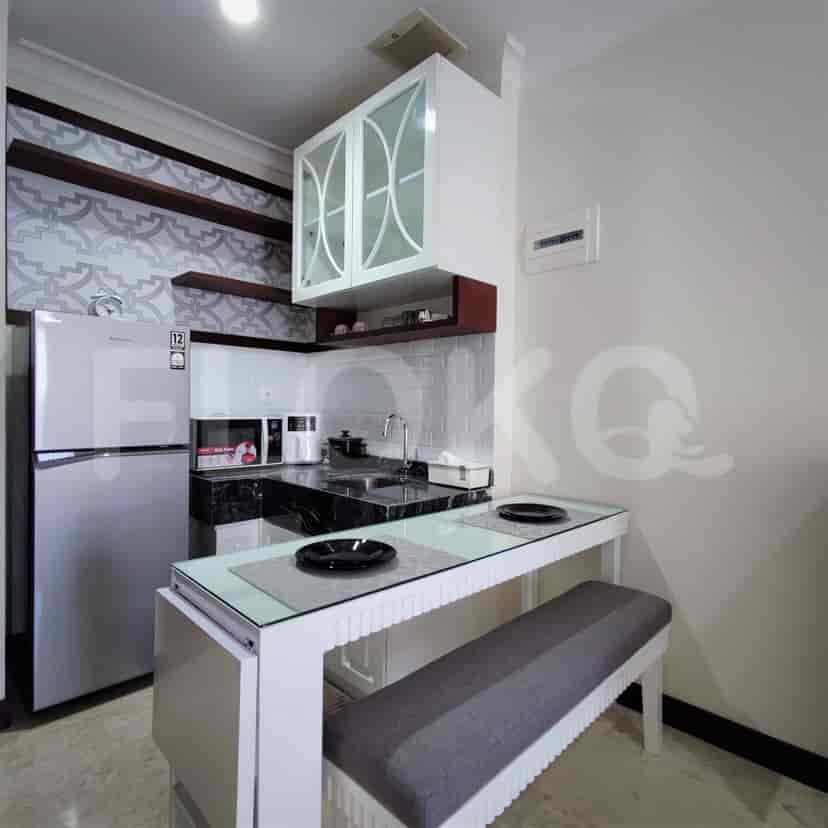 A well-equipped kitchen featuring a refrigerator and a dining table.