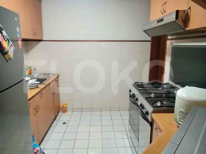A compact kitchen space featuring essential appliances and cabinets.