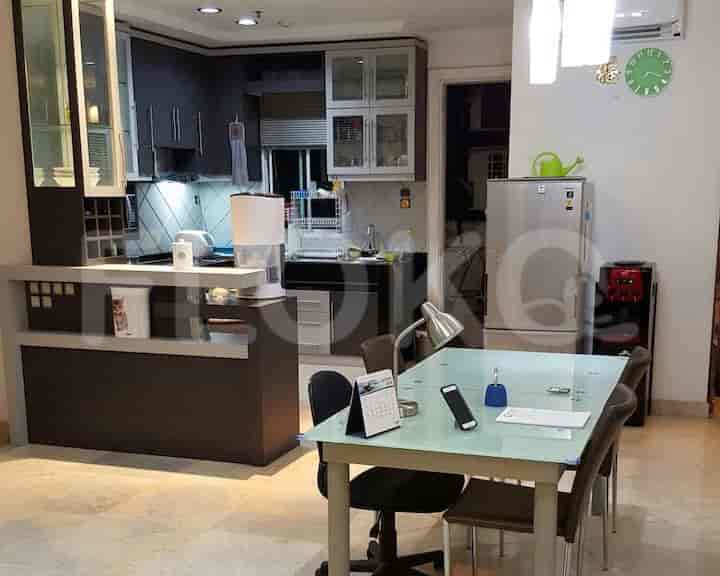 Kitchen and dining area with a dining table and kitchen cabinets.