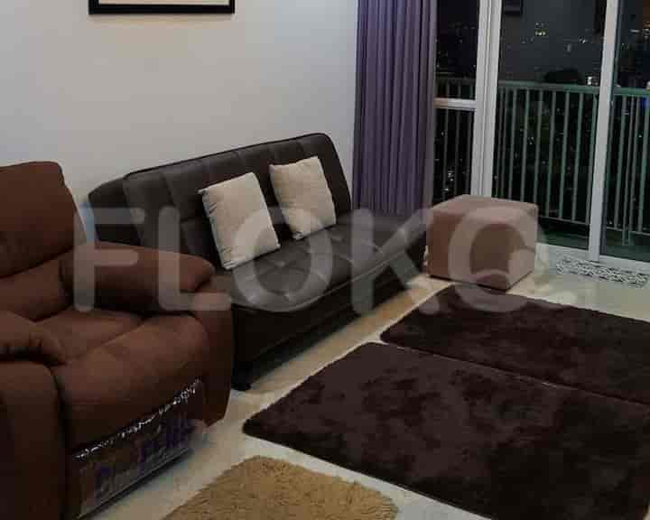 Living room with a recliner, futon, and rugs.