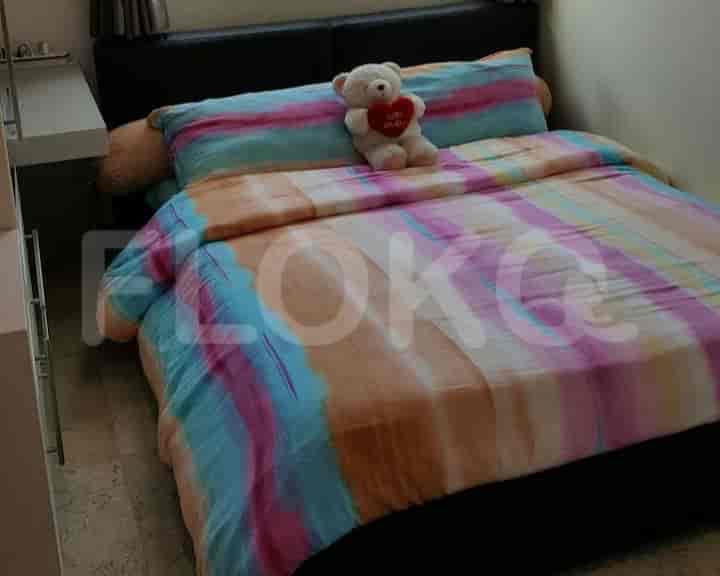 Bedroom with double bed and colorful bedding.