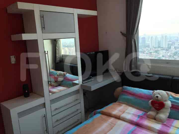 Bedroom with a bed, wardrobe, and a TV.