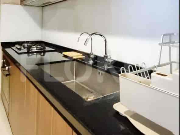 A compact kitchen counter with a gas stove, sink, and faucet.