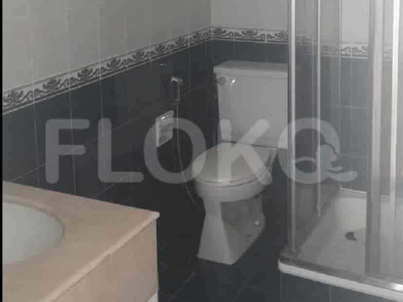 A bathroom with a toilet, sink, vanity, and a shower enclosure.