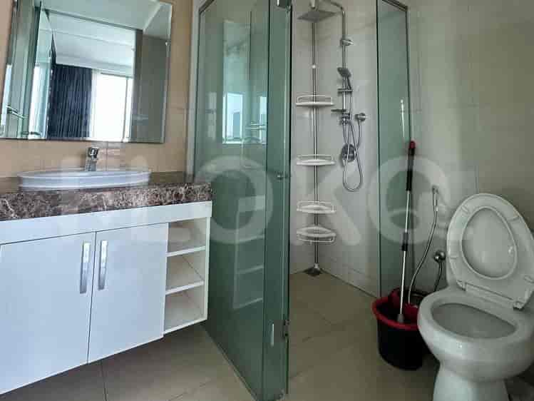 A modern bathroom with a vanity, sink, and a glass-enclosed shower.