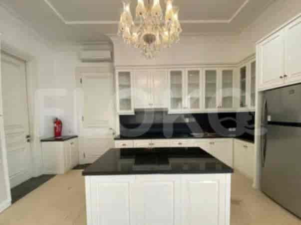 A modern kitchen with white cabinetry, a central island, and stainless steel appliances.
