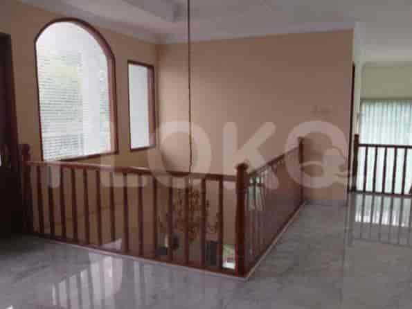 A staircase with wooden handrails leading to the upper floor with natural light.