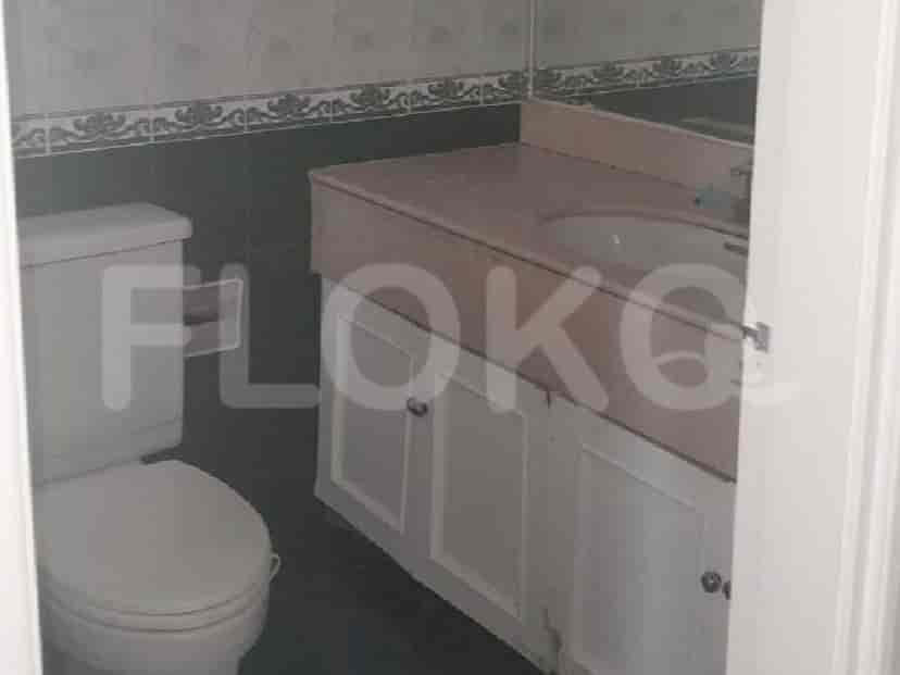 A bathroom with a toilet, vanity, and sink.