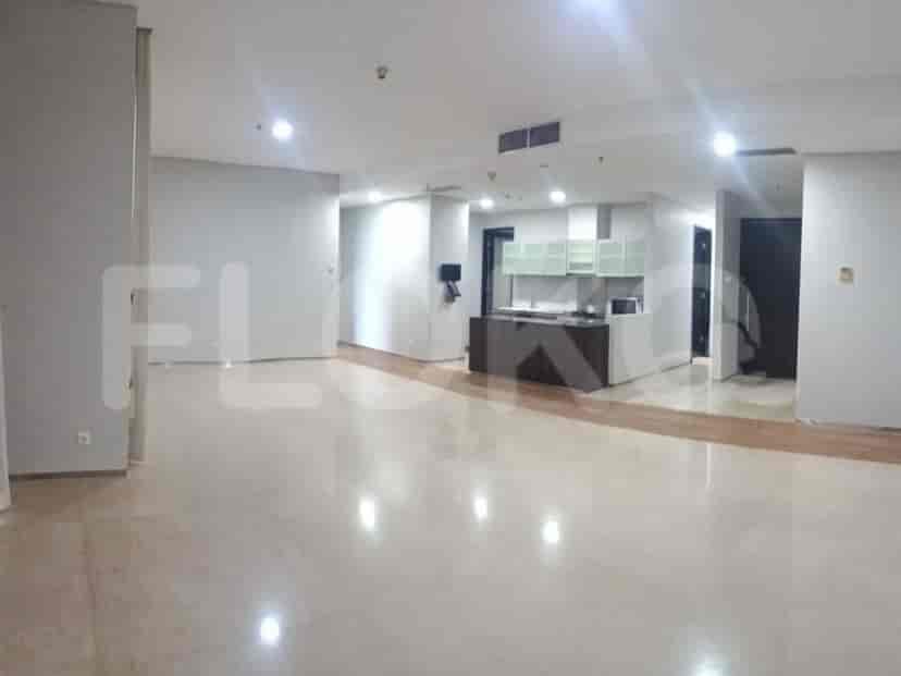 Spacious living room with marble flooring and a modern open kitchen.