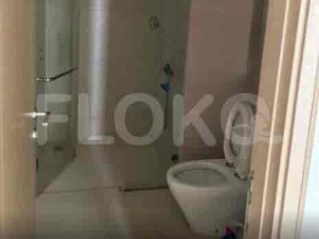 A bathroom with a toilet and a glass-enclosed shower.